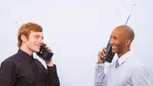 Men talking on old cell phones